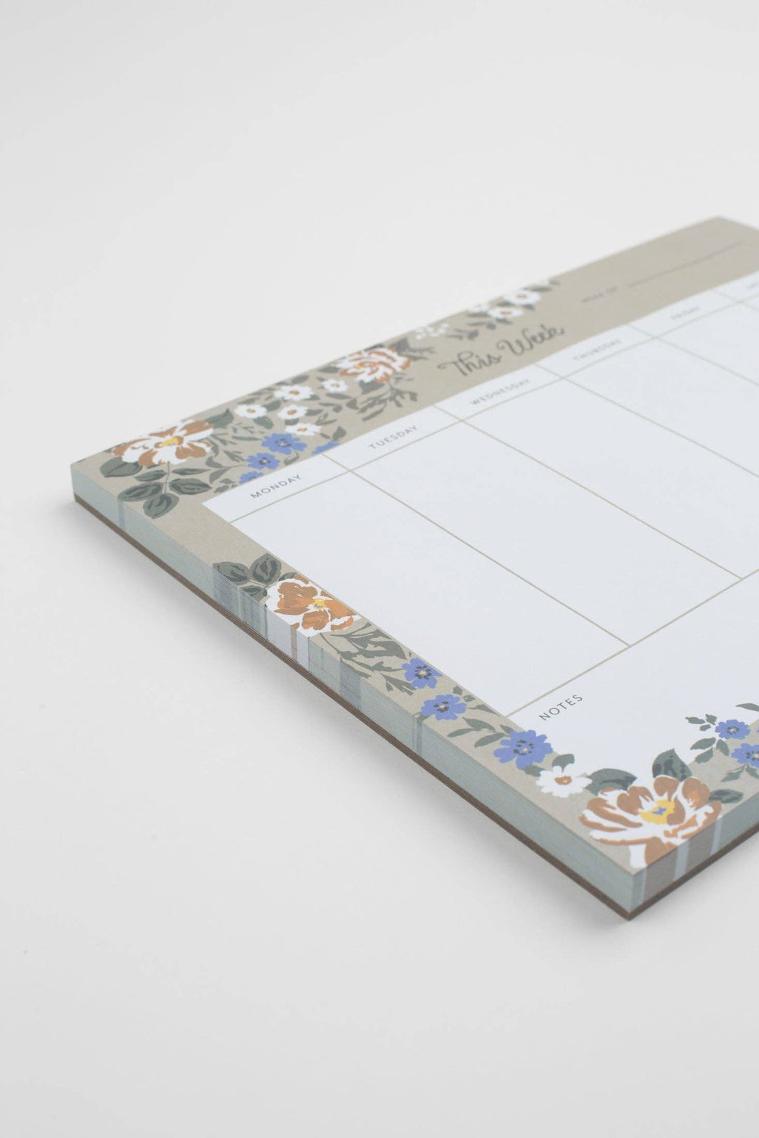 Floral-patterned notepad with a grid layout on a white background