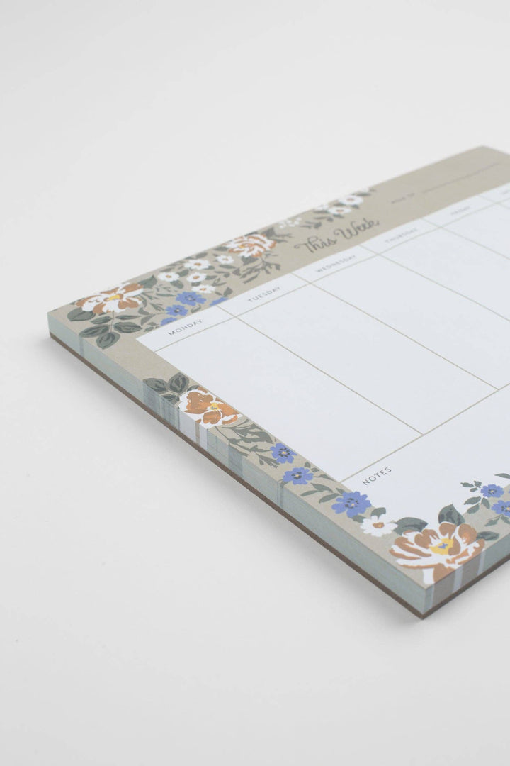 Floral-patterned notepad with a grid layout on a white background