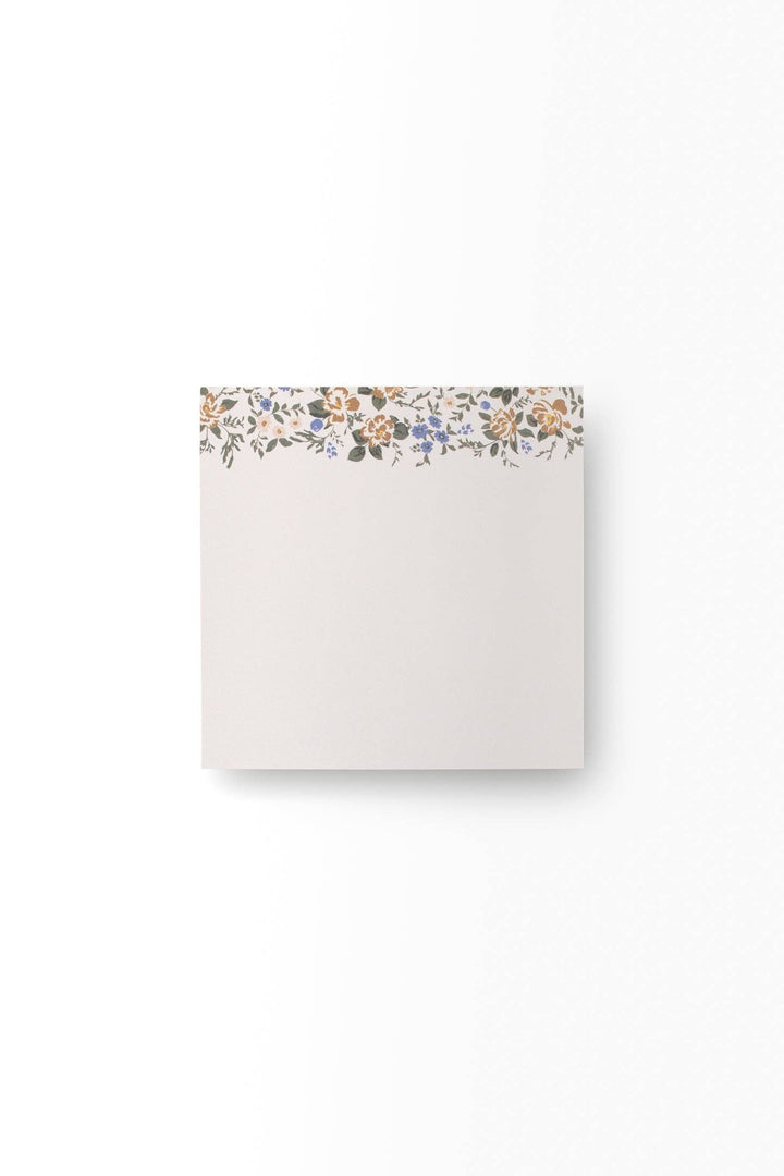 Note pad with floral design on a white background
